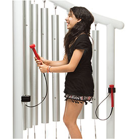 Girl playing on the Chimes outdoor musical instrument 